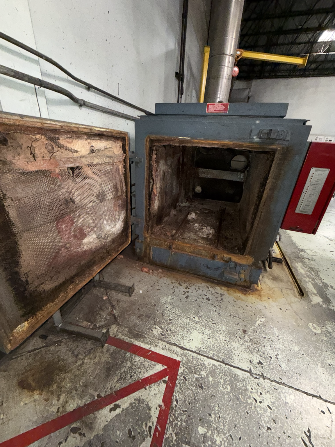 Burn-off oven before rebuild — worn refractory and damaged components